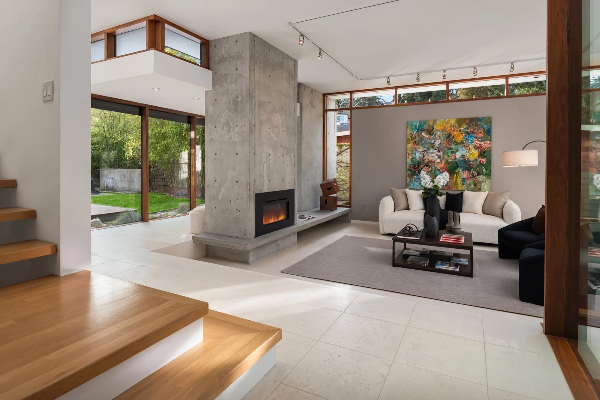 A large floral painting placed in a double-height living room