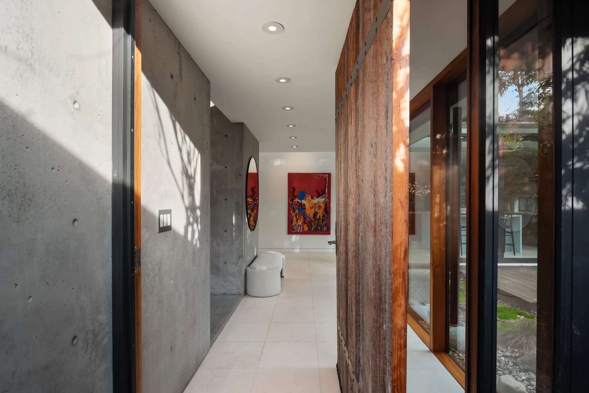 A red contemporary painting closing the view down a concrete hallway