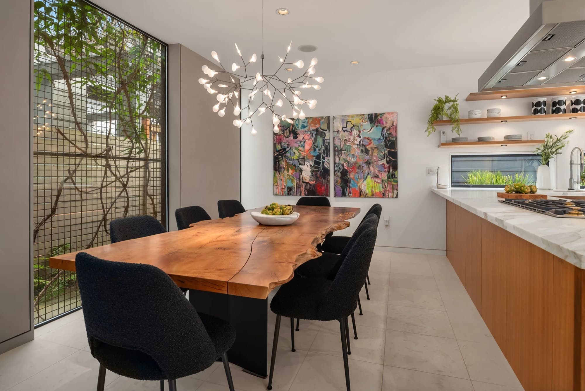 A contemporary diptych placed above a live-edge dining table