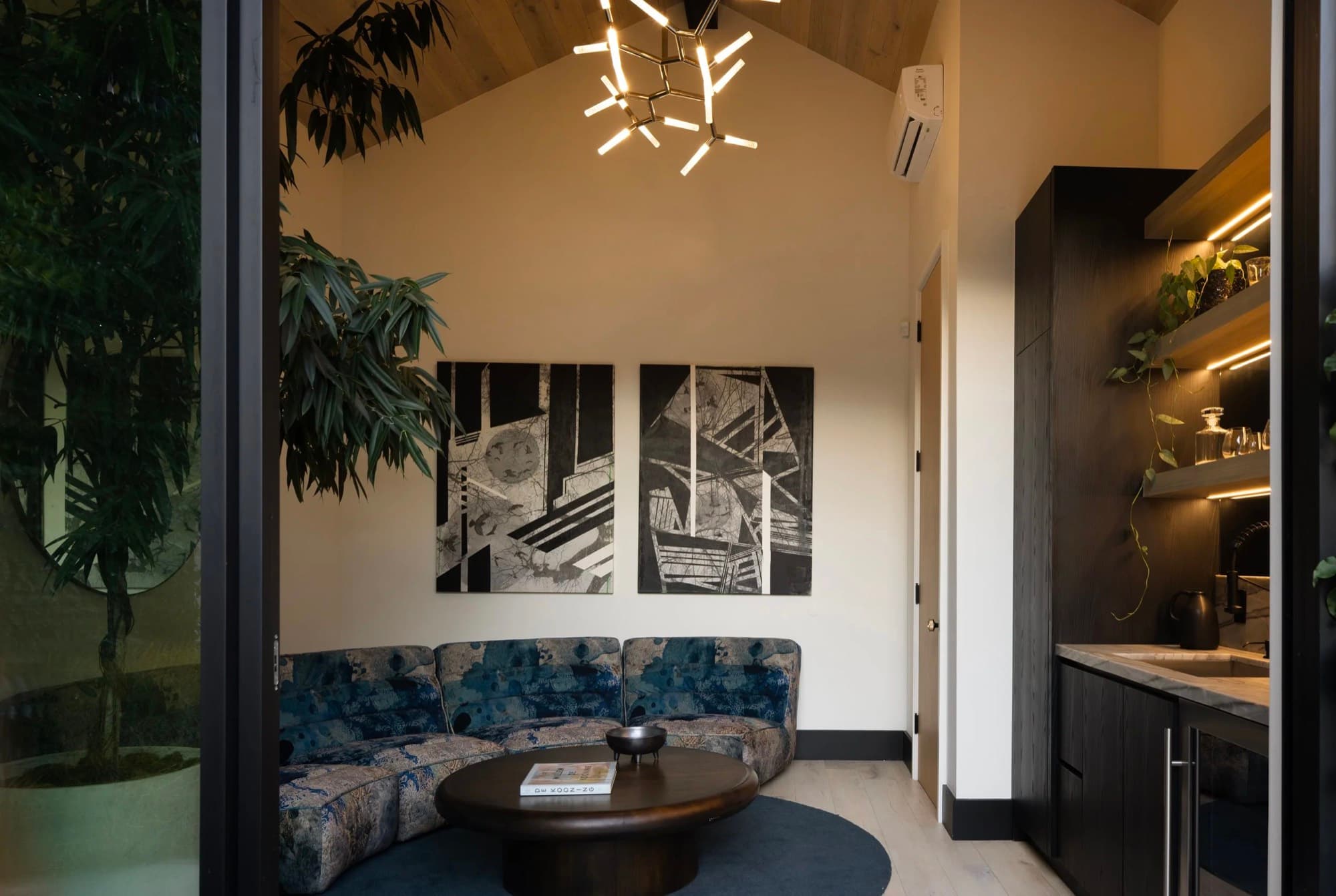 A black-and-white diptych placed above a curved banquette