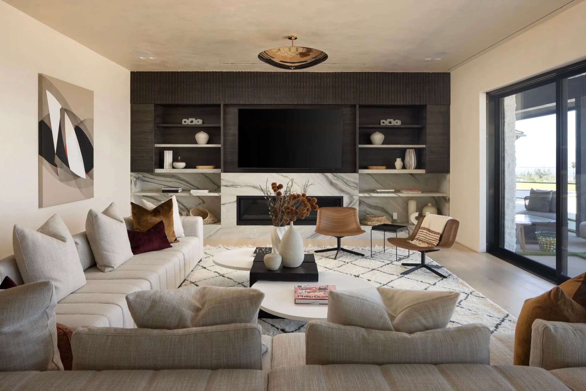 An abstract work placed beside a stone fireplace in a family room