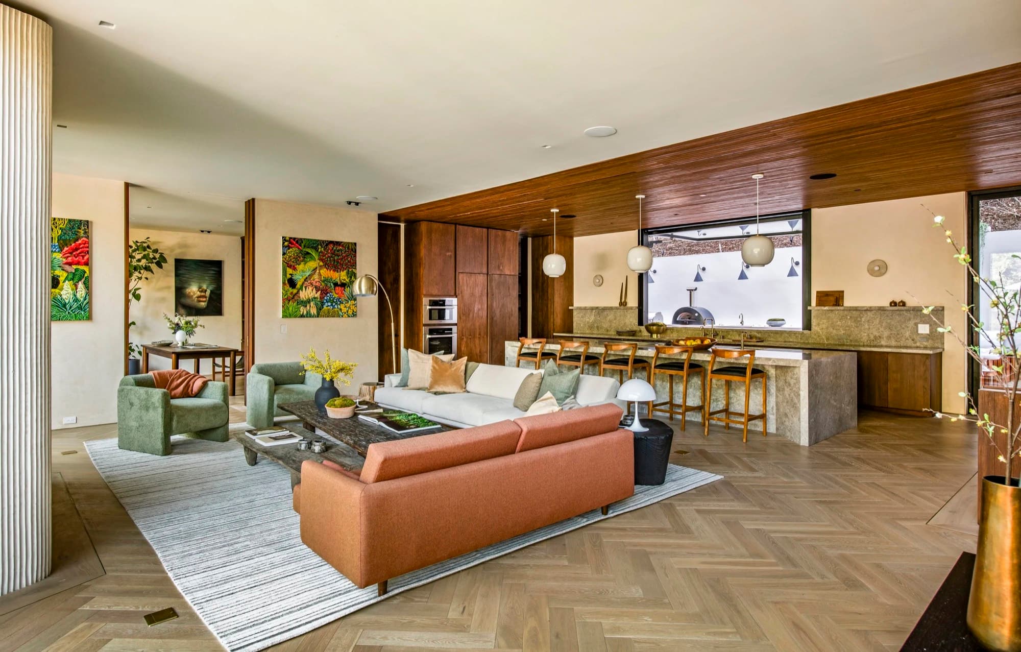 Contemporary paintings placed through an open-plan living room